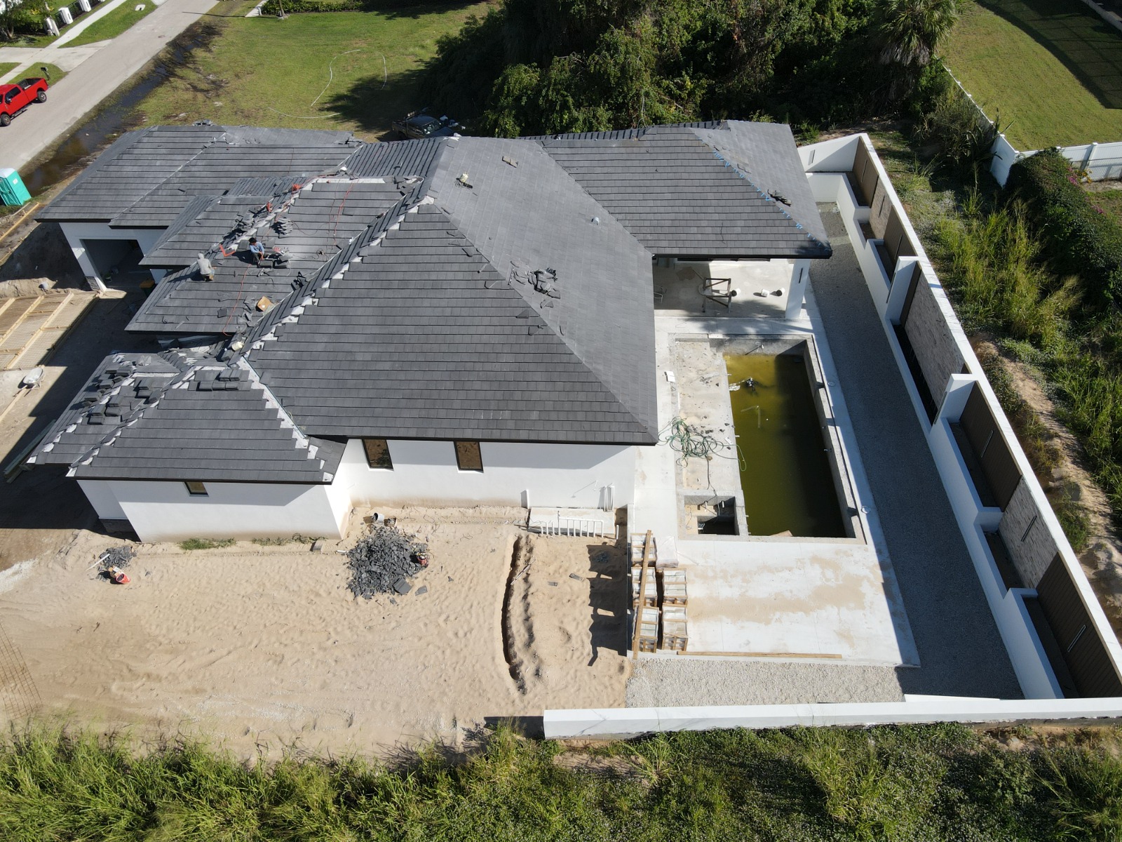 How Often Should You Document Construction Progress with Drone Photography? 1 Construction drone photography of tile roof installation in Naples, FL — TrueVision Photography