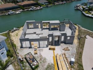 Blog 11 Construction progress drone photo of a Naples, FL waterfront home shell — TrueVision Photography
