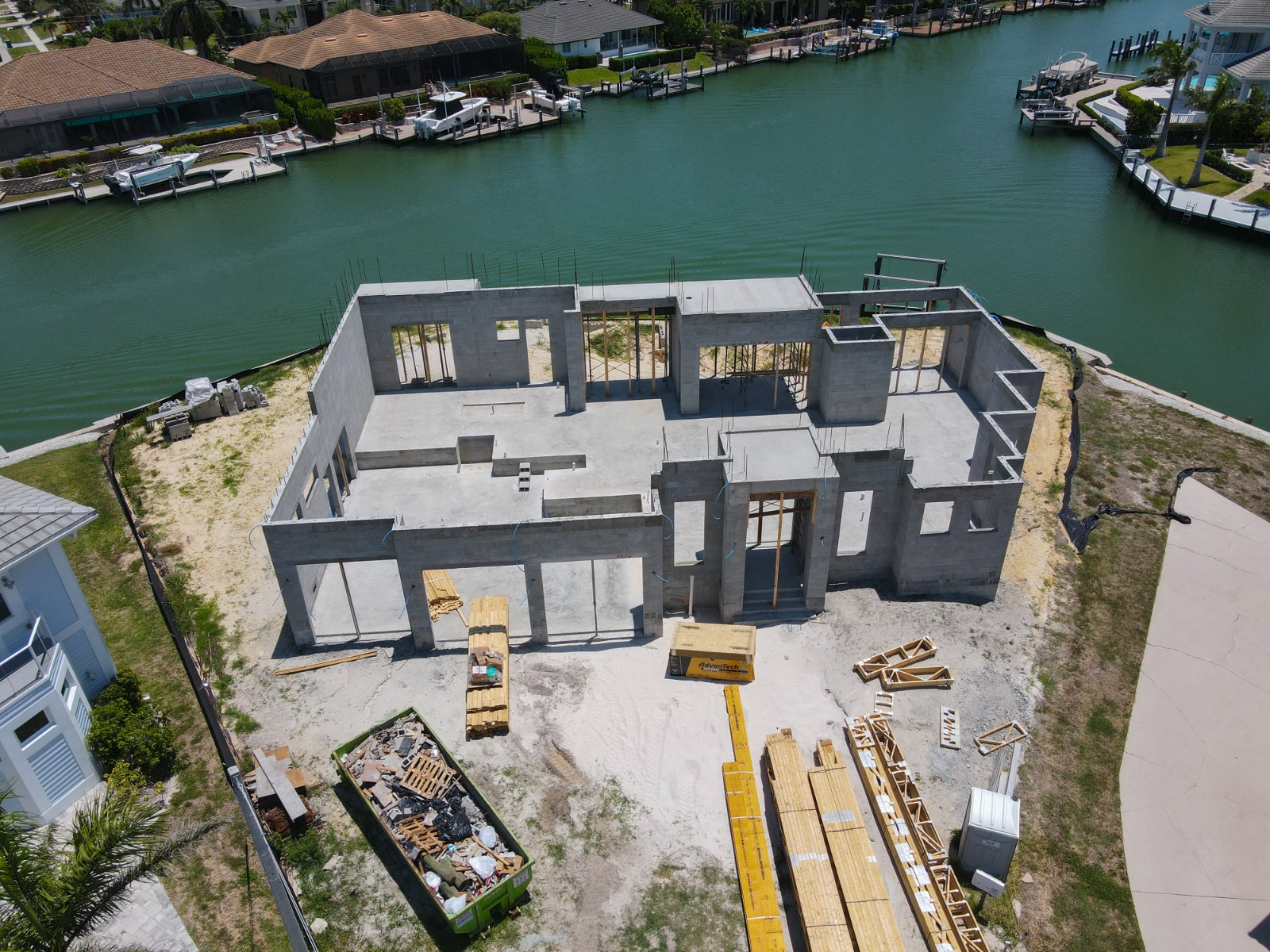How Often Should You Document Construction Progress with Drone Photography? 2 Construction progress drone photo of a Naples, FL waterfront home shell — TrueVision Photography