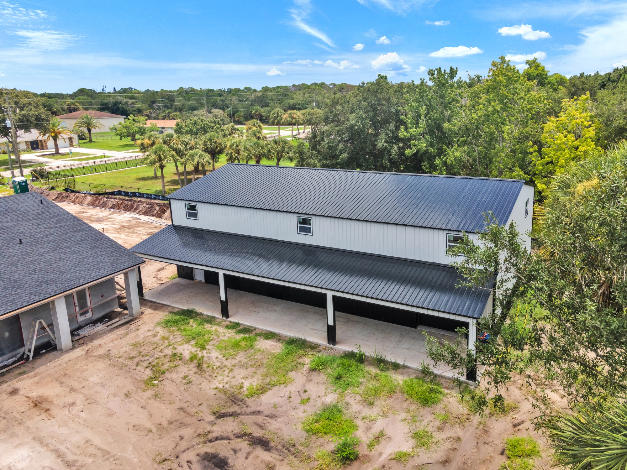 Aerial photo of a completed metal building and cleared construction site during a progress shoot